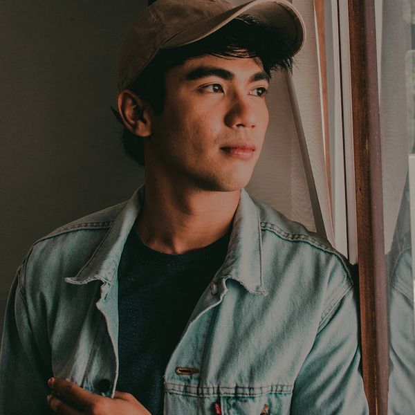 Man in a calm, focused state after a workout, looking out a window.